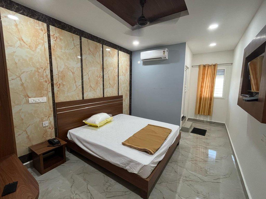 A guest room at MM Residency, made up with the bed turned down